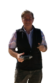 Headshot of Colin Dixon on a pebbly beach.